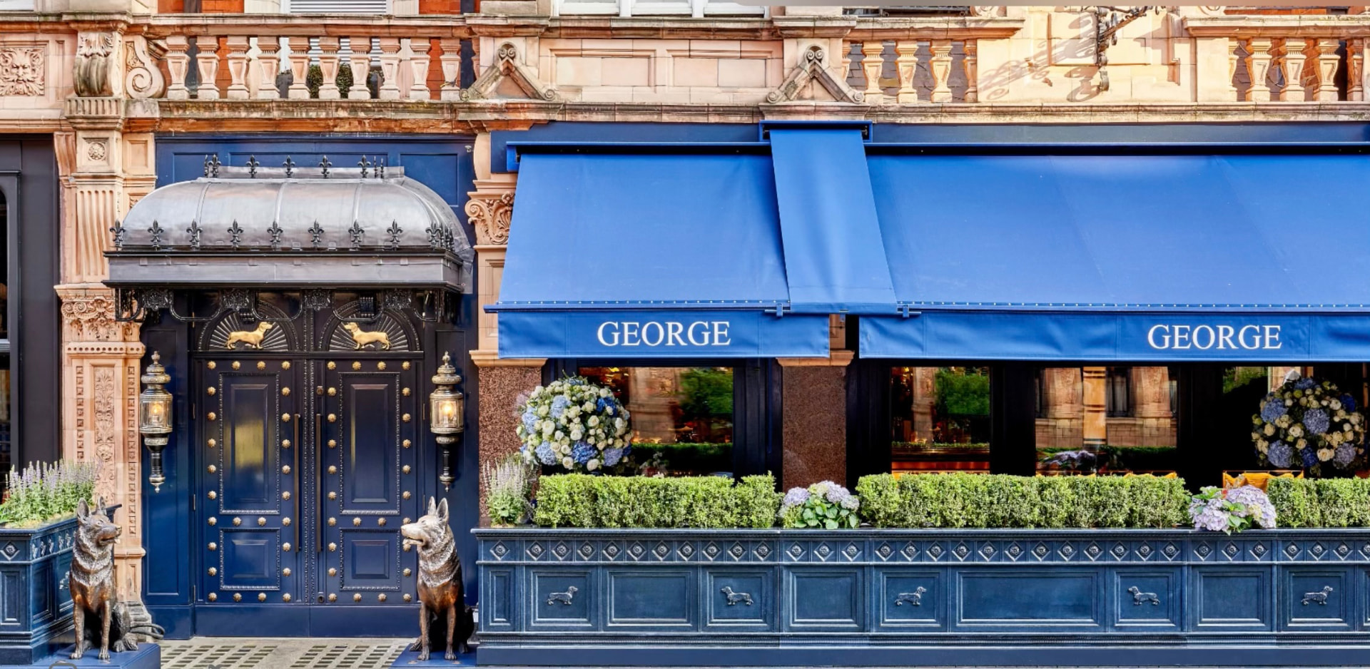 The facade of George on Mount Street, navy joinery, blue awnings and bronze dachshunds