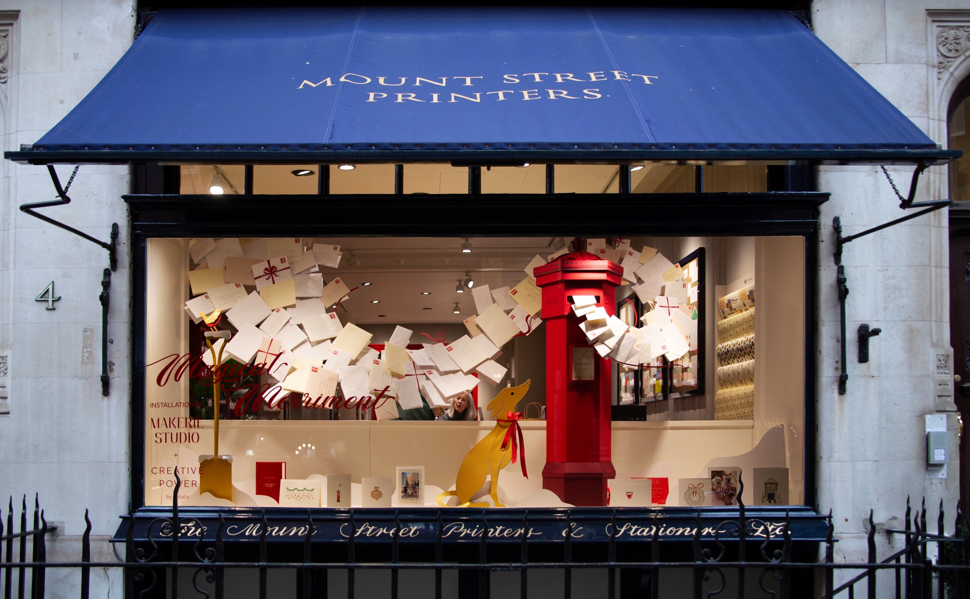 The window of Mount Street Printers, its blue awning above a display of hand-written letters