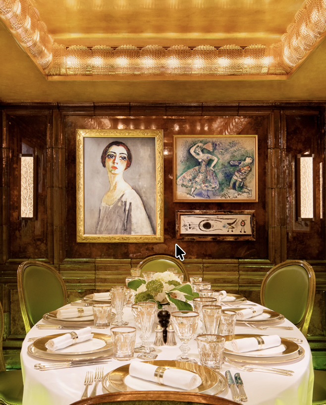 A dining room hung with a Renoir portrait and a Degas, a round table dressed for dinner